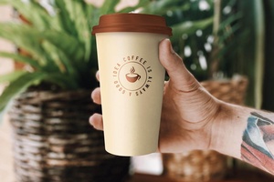 Hand Holding 20 oz Paper Coffee Cup Mockup